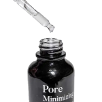 Dropper dispensing serum into pore minimizing bottle.