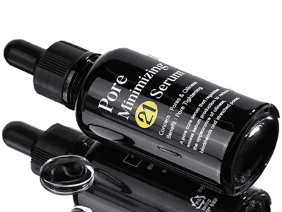 Pore minimizing serum bottles on reflective surface.